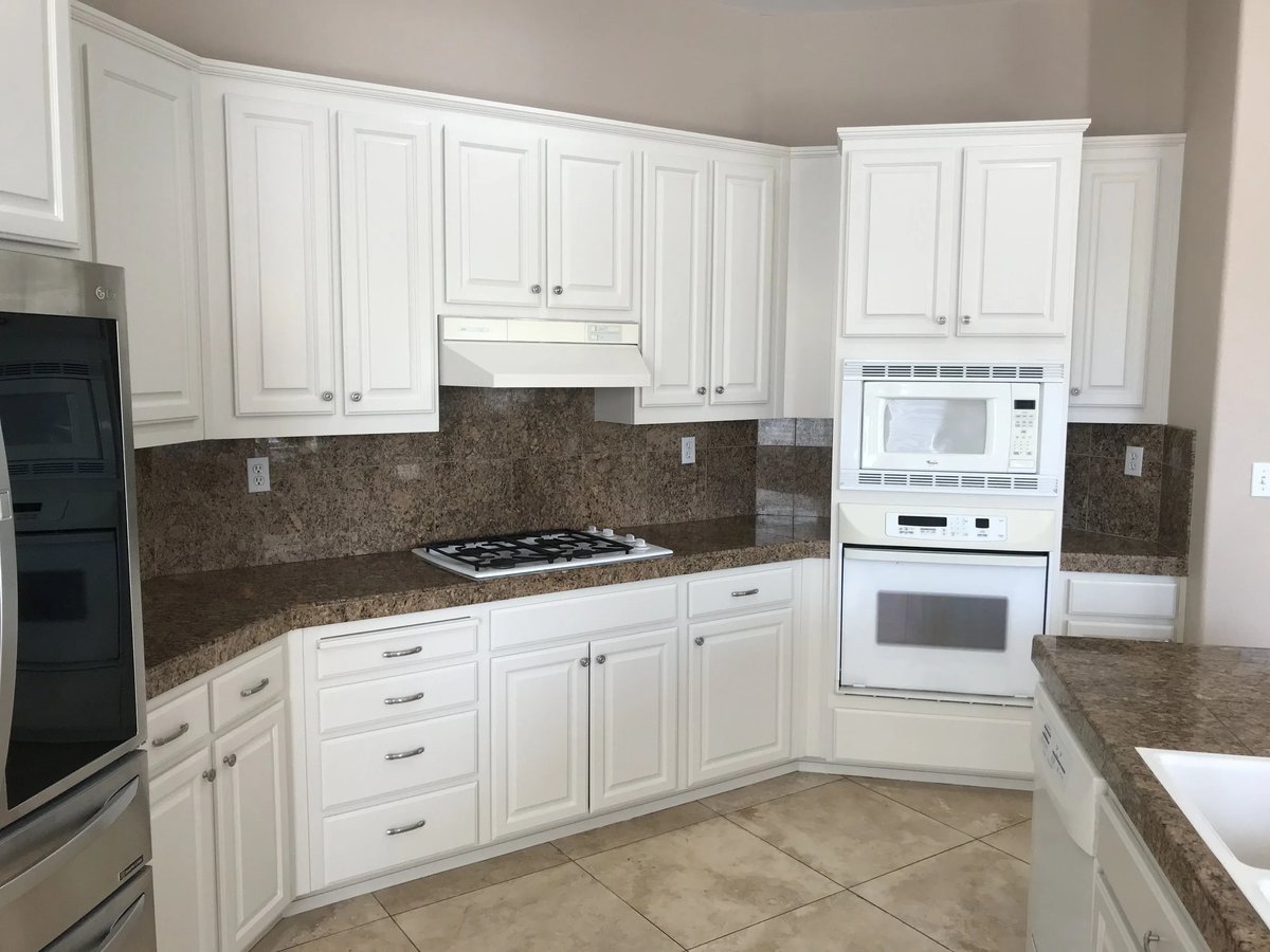 Same kitchen with cabinets refinished in white