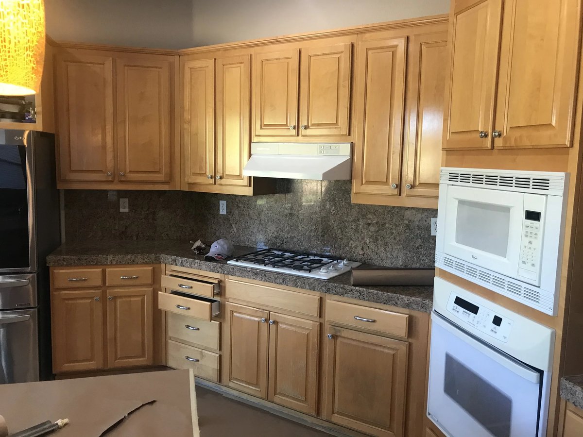 Kitchen with dated oak cabinets before refinishing