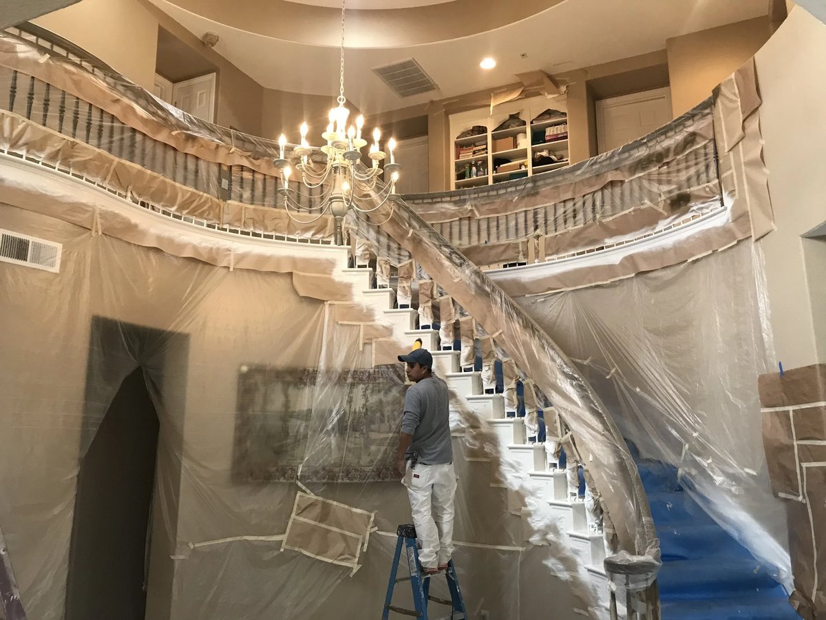 Two-story foyer fully masked and protected before painting
